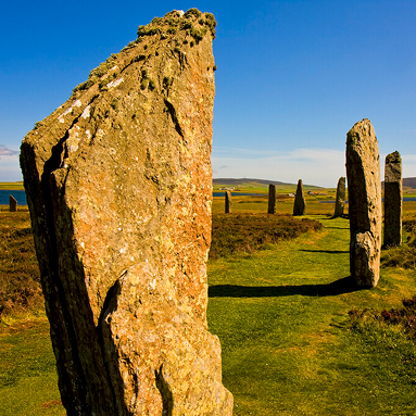 Ring of Brodgar stone circle under dramatic Scottish clouds.