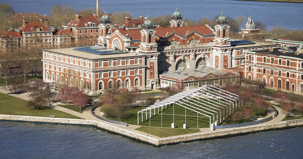 Aerial view of the Ellis Island museum complex showing the historic brick buildings.